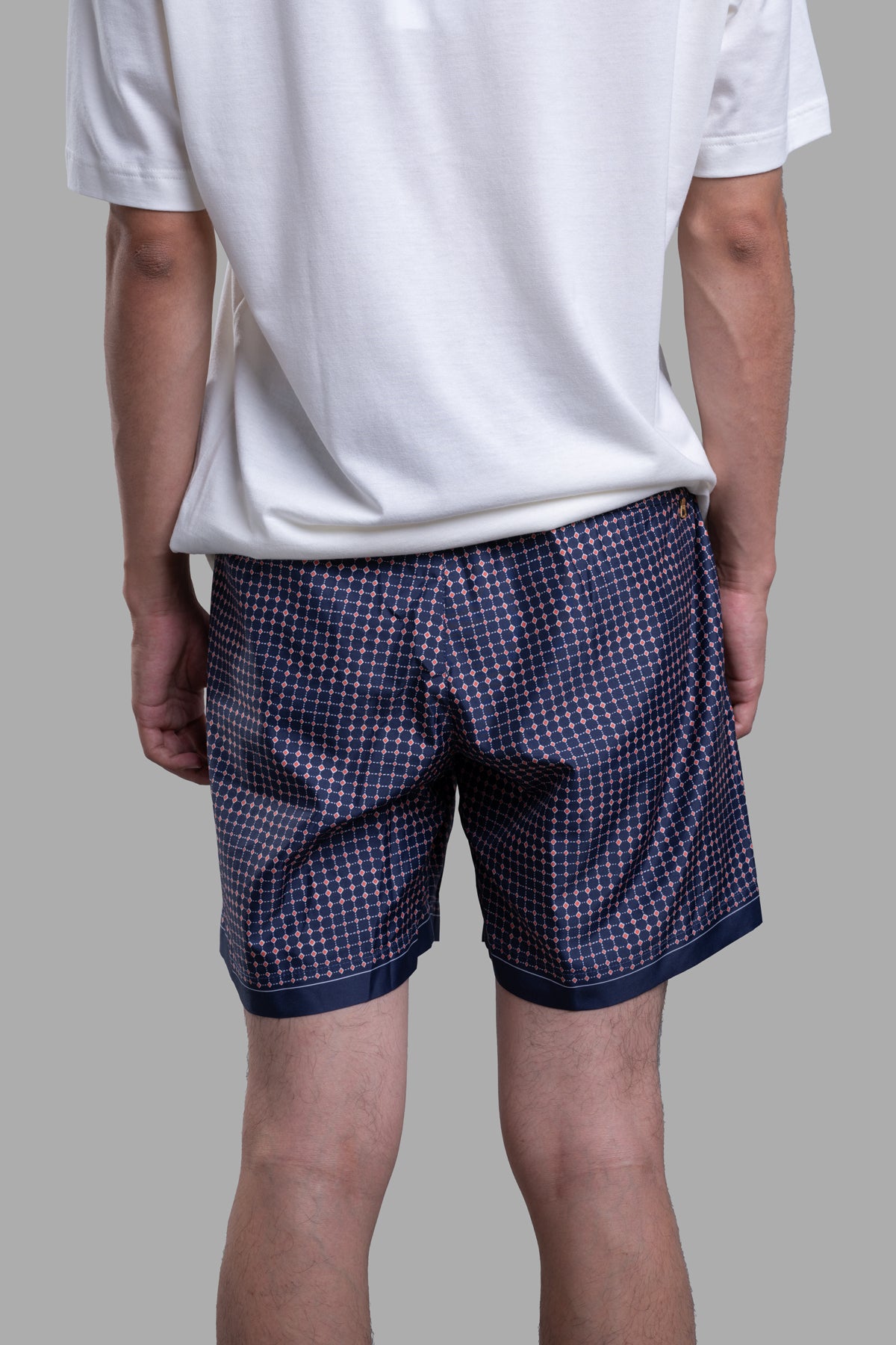 Orlebar Brown Drawcord Swim Shorts in a striking blue and red diamond print, showcased from the back view on a model.