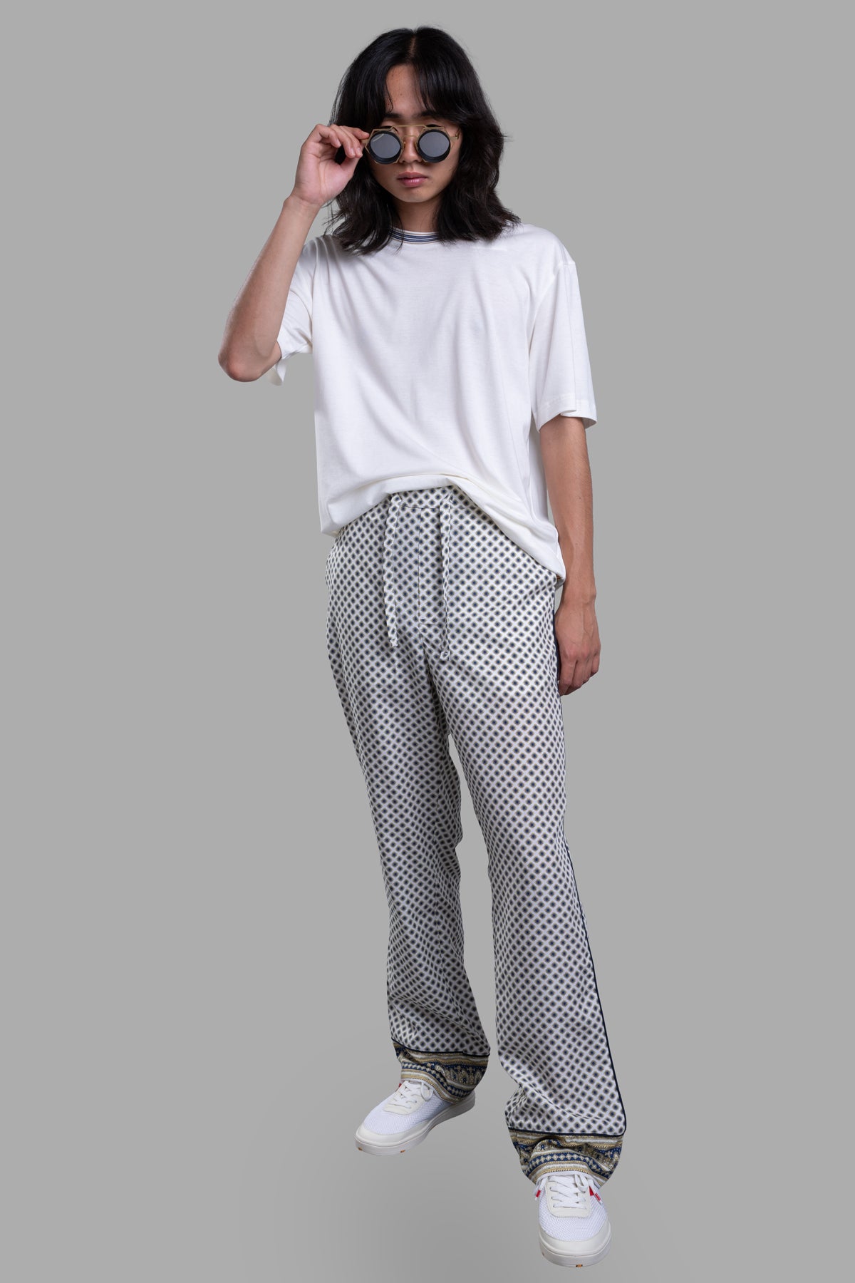 Orlebar Brown Relaxed-Fit Lounge Trousers, front view, geometric floral print, with paisley hem and drawcord waist on model.