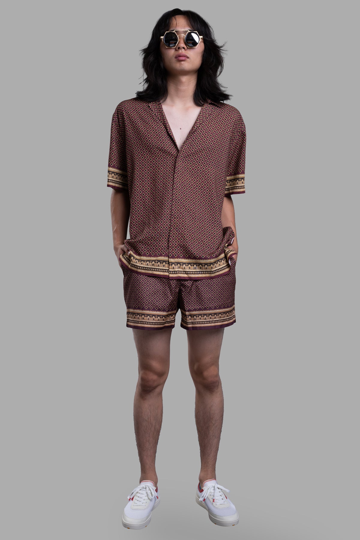 Orlebar Brown Relaxed-Fit Capri Shirt in deep red, front view on model. Features floral geometric print and paisley accents.