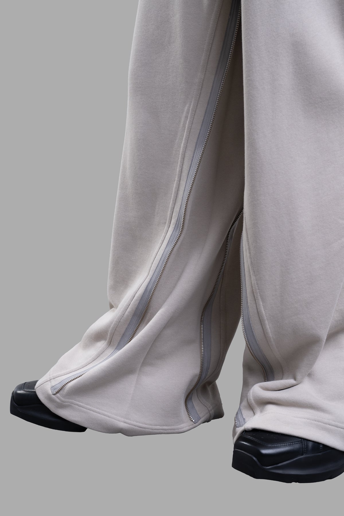 Helmut Lang Gusset Sweatpants in grey, featuring side zippers for adjustable fit and soft cotton terry texture.