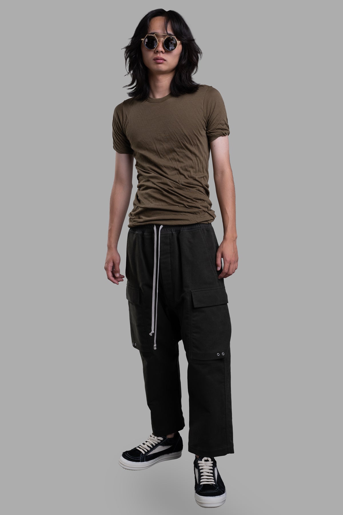 Rick Owens Cropped Drawstring Pants in green, front view, on-model, featuring dropped crotch and side pockets.