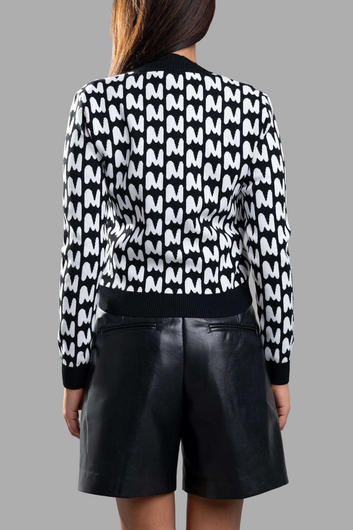 MSGM Jacquard Cardigan featuring a back view with iconic M pattern, slim fit, and contrasting ribbed hem. Black/White color.
