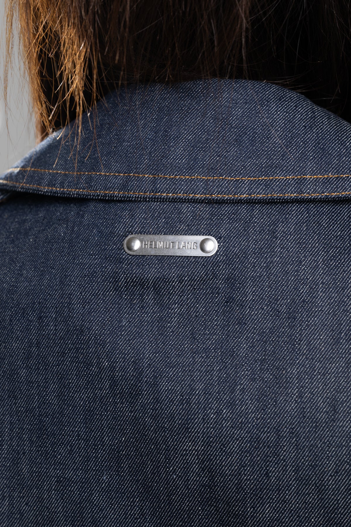 Helmut Lang Denim Trench Jacket, showcasing raw indigo fabric and signature label detail on the back collar.