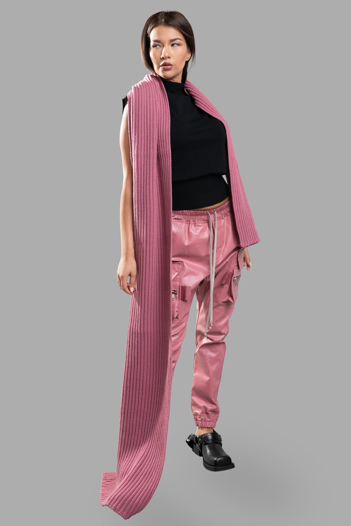 Rick Owens pink Coated Cargo Pants on-model, front view, elastic waistband, multiple pockets, and secure ankle fit.