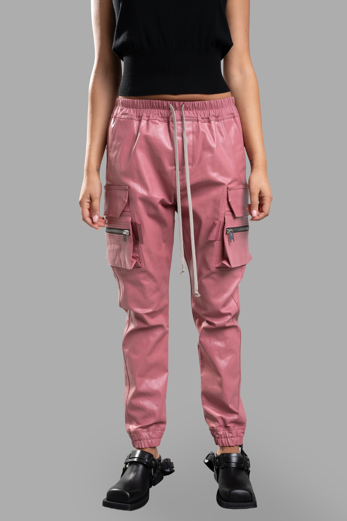 Rick Owens Coated Cargo Pants in pink, featuring an elasticated waistband and multiple pockets, shown front view.