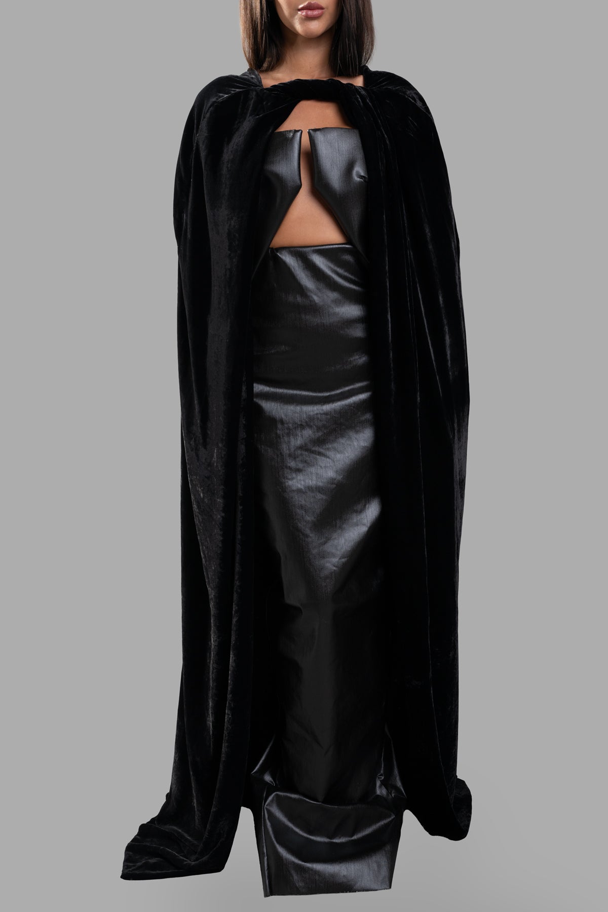 Rick Owens Porterville Masto Cape displayed on model, featuring luxurious black velvet with a floor-length design and twist.