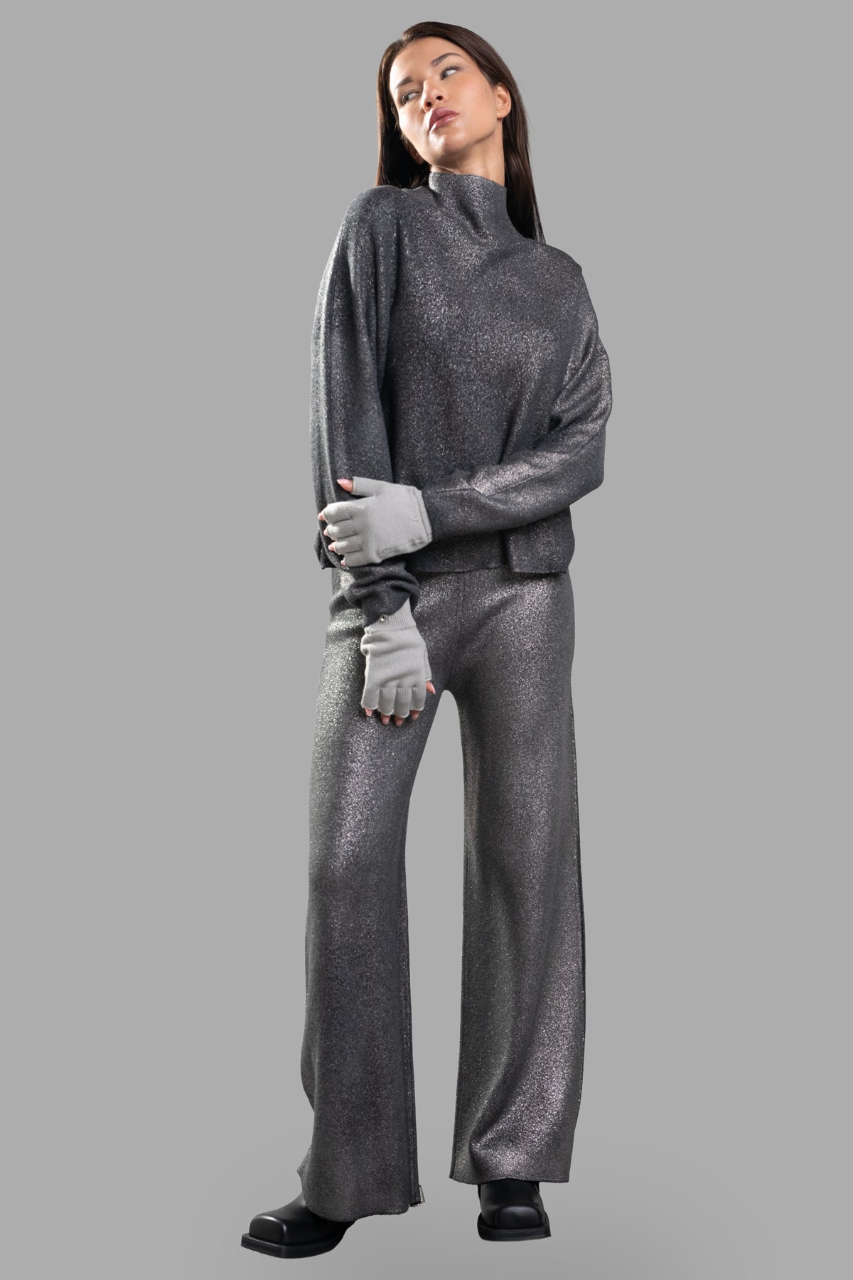 Avant Toi Lamé Knit Pants styled with matching sweater, showcasing high-waist, wide-leg design in grey/gold lamé finish.