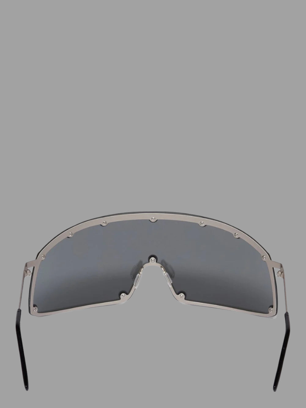 Rick Owens Shielding Sunglasses with a sleek silver stainless steel frame and straight black lenses, featuring a rubber nose.