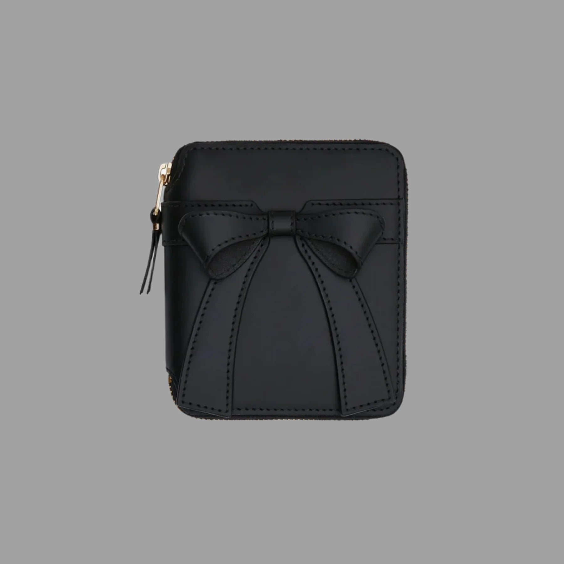 Comme des Garçons Big Bow Wallet, front view, showcasing large bow and sleek design in black leather. Image 1 of product series.