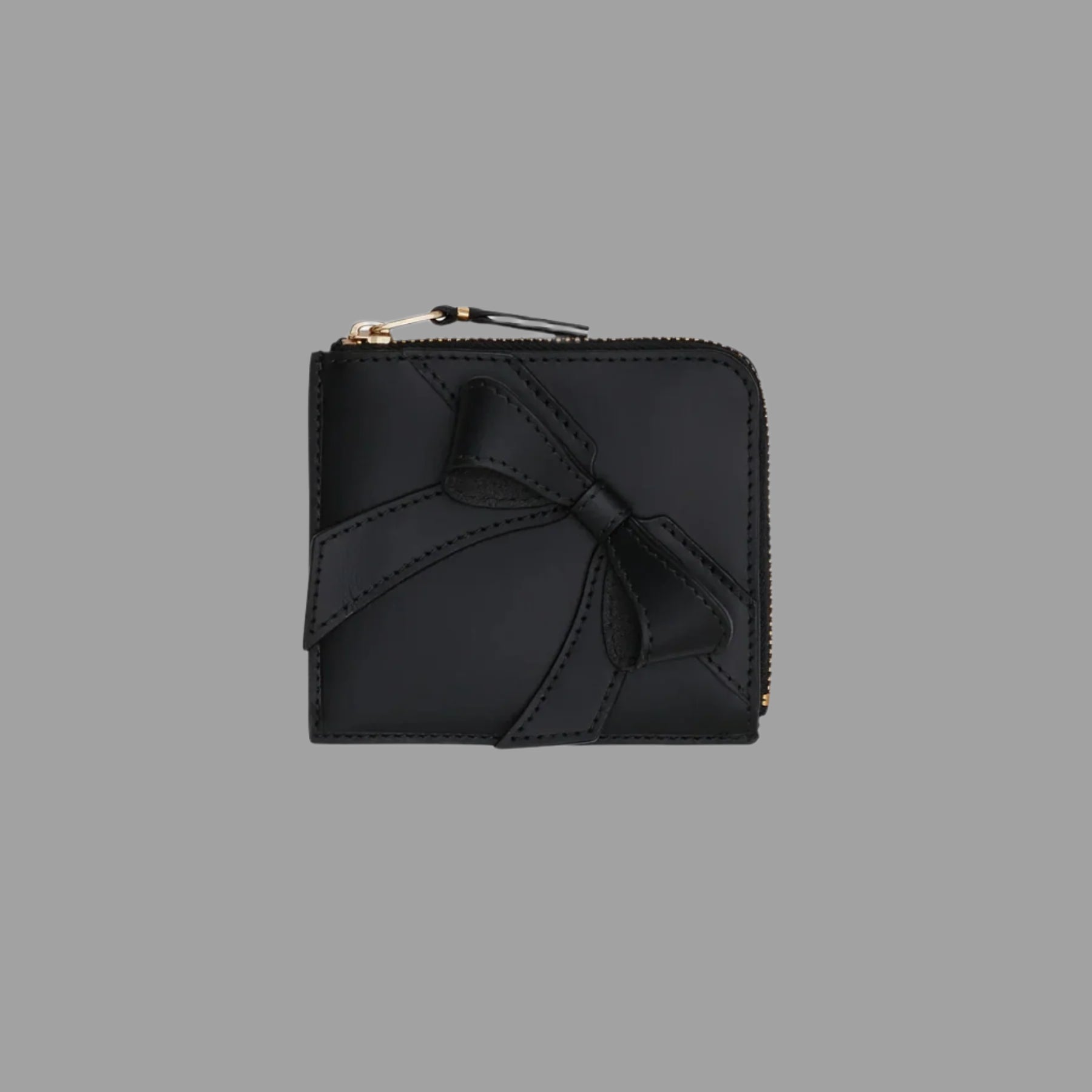 Comme des Garçons Half-zip Bow Wallet, black leather with large bow detail, front view.