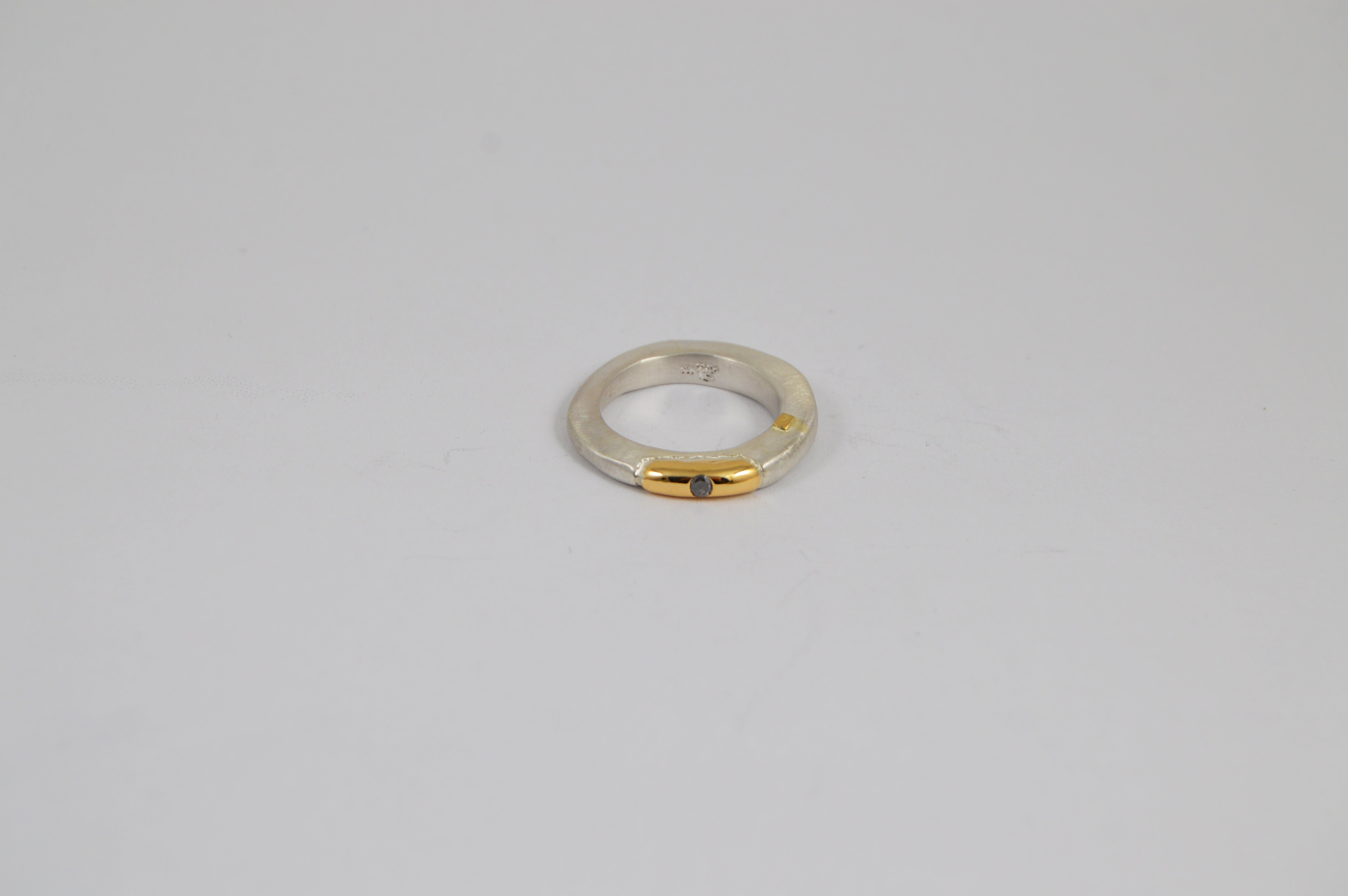 Rosa Maria Sapho Ring close-up, showcasing sterling silver band with 18k yellow gold detail and icy grey diamond.
