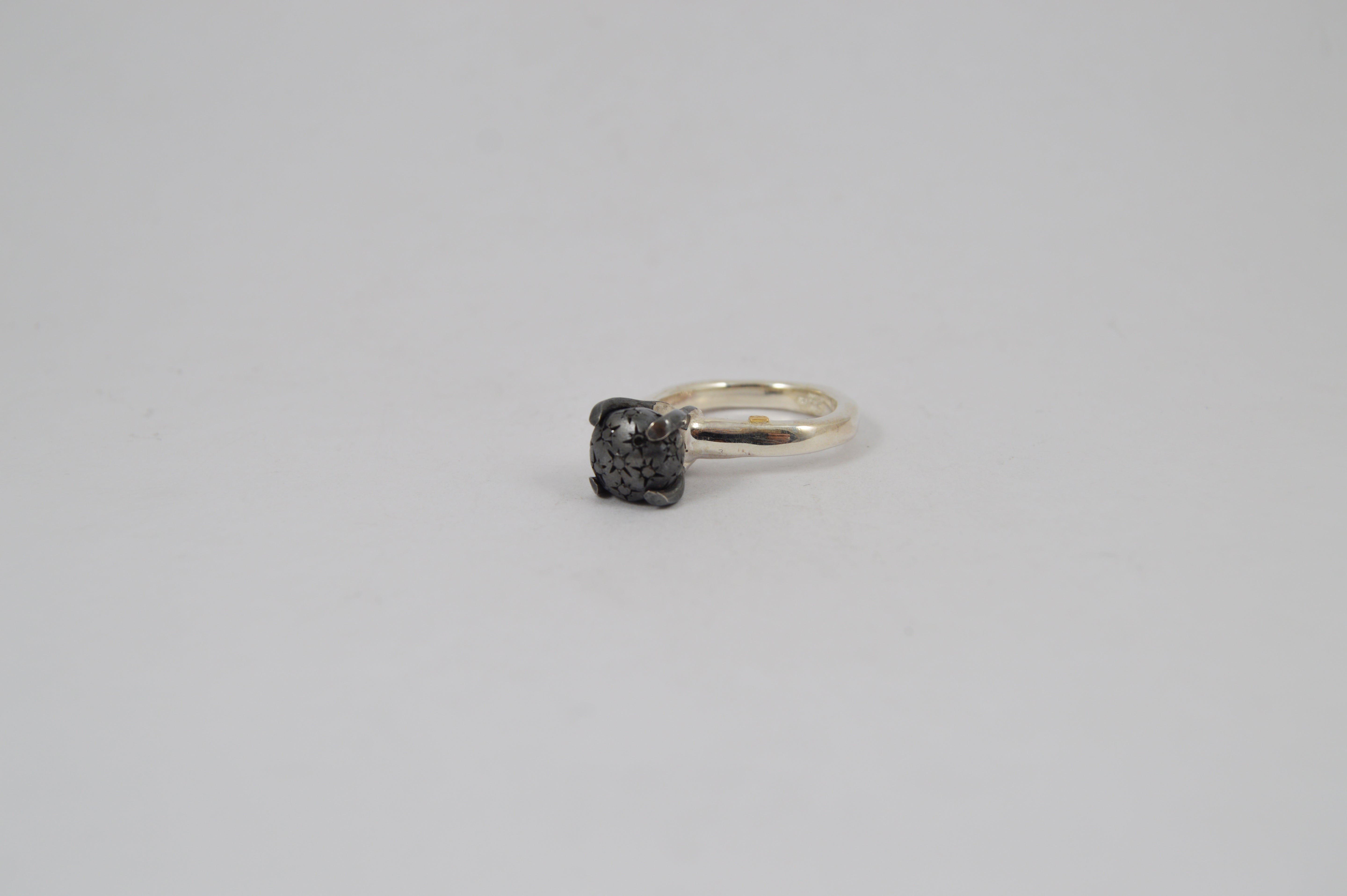 Rosa Maria Yoko Ring featuring a silver band with a raw, textured dark stone front view.
