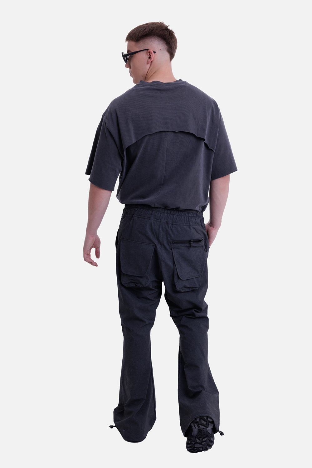 Justin Gall men's after flow pants in black enzyme, rear on-model view with oversized back patch pockets