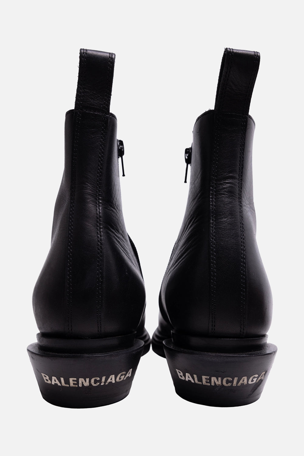 Pre-owned Balenciaga women’s ankle boots in black, back view, rear pull tabs and Balenciaga logo on the heel.