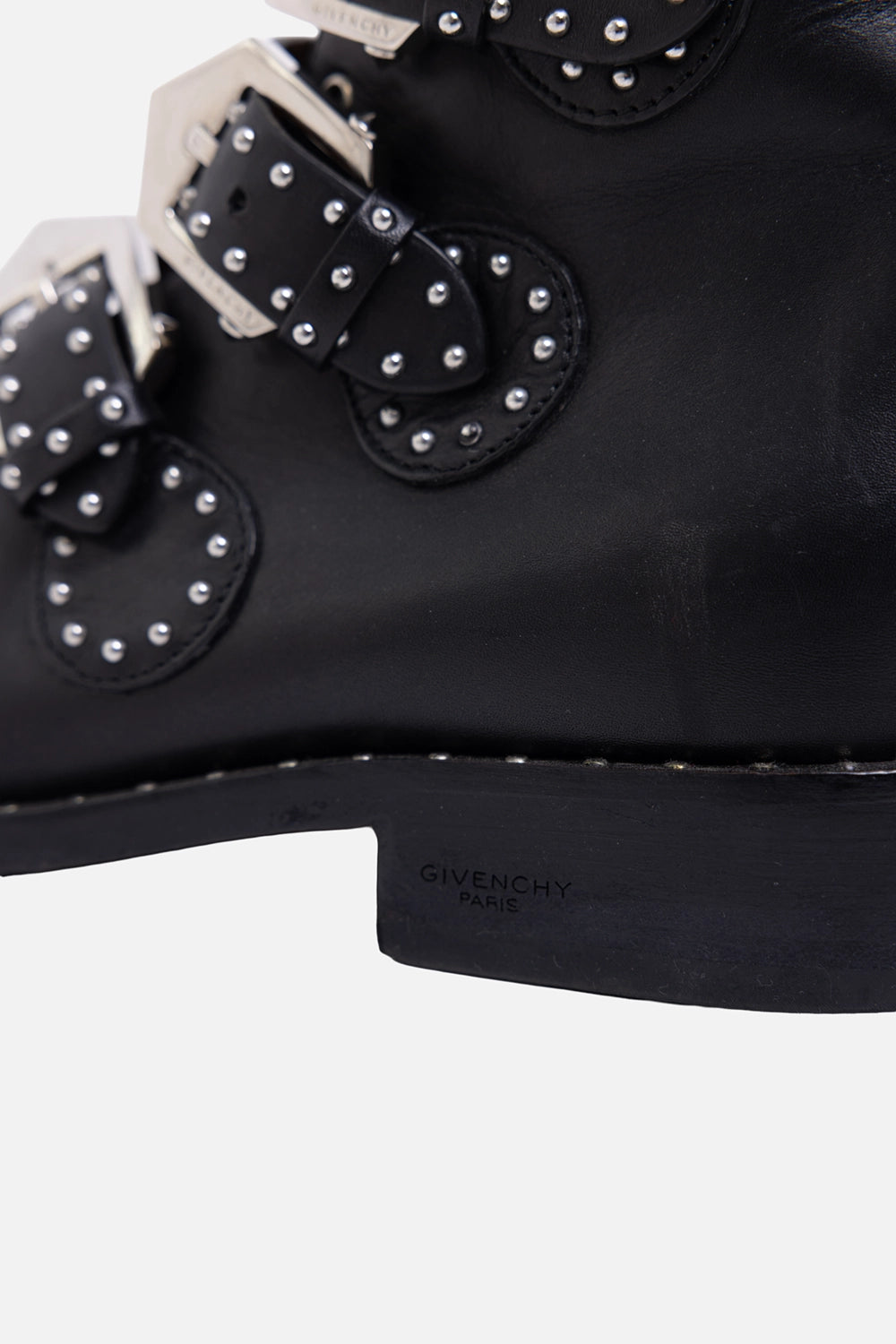Pre-owned Givenchy ankle boots in black, heel close-up, logo stamp and studded straps