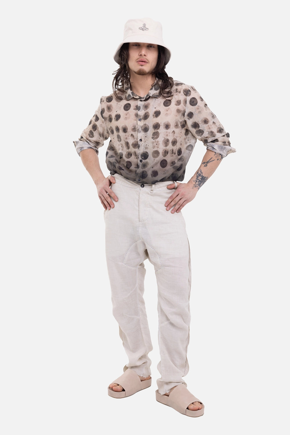 Masnada men's baggy ramie trousers in cement, on-model full-length view, low crotch and button waist