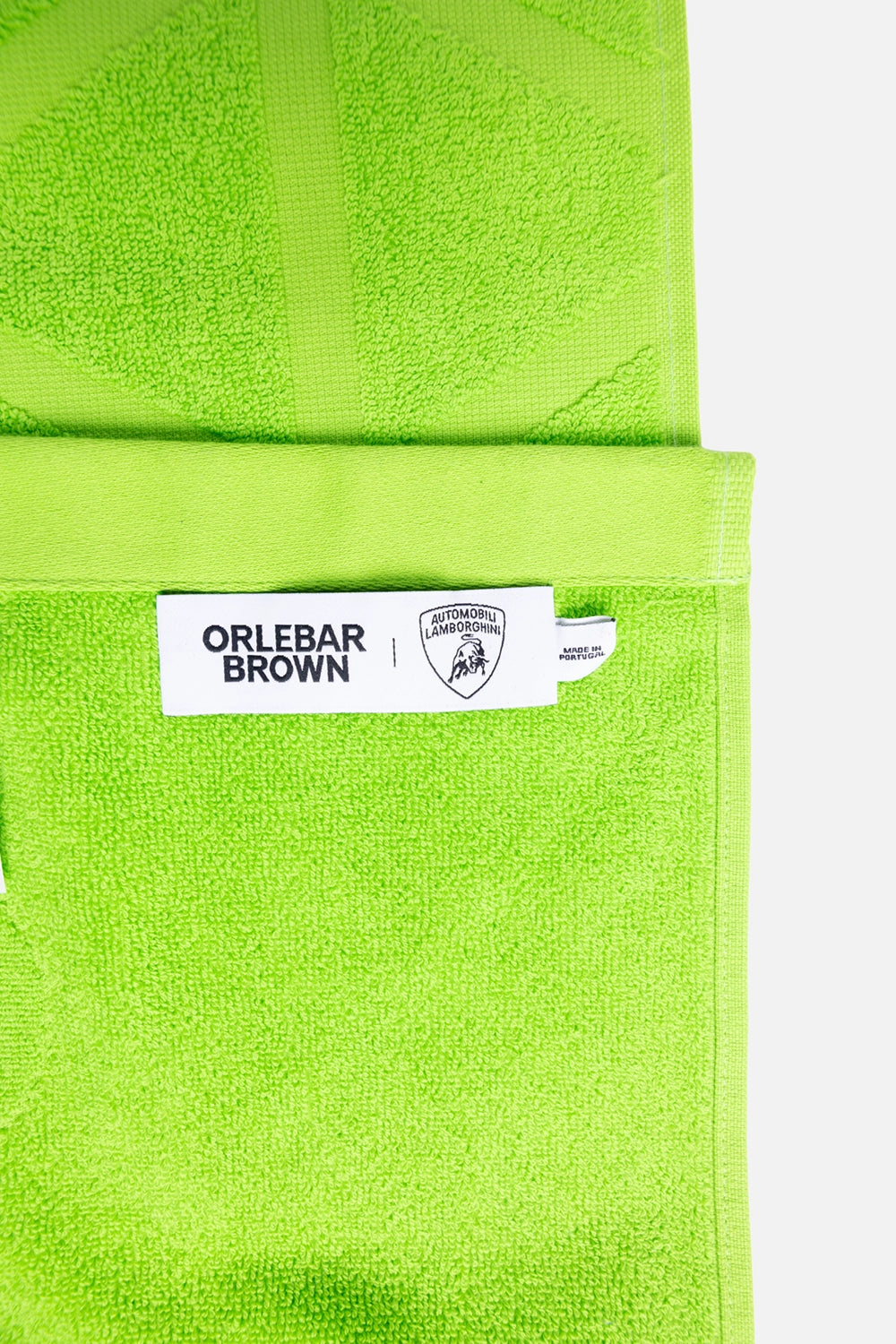 Orlebar Brown unisex beach towel in Verde Mantis, label detail, co-branded Orlebar Brown and Lamborghini woven tag
