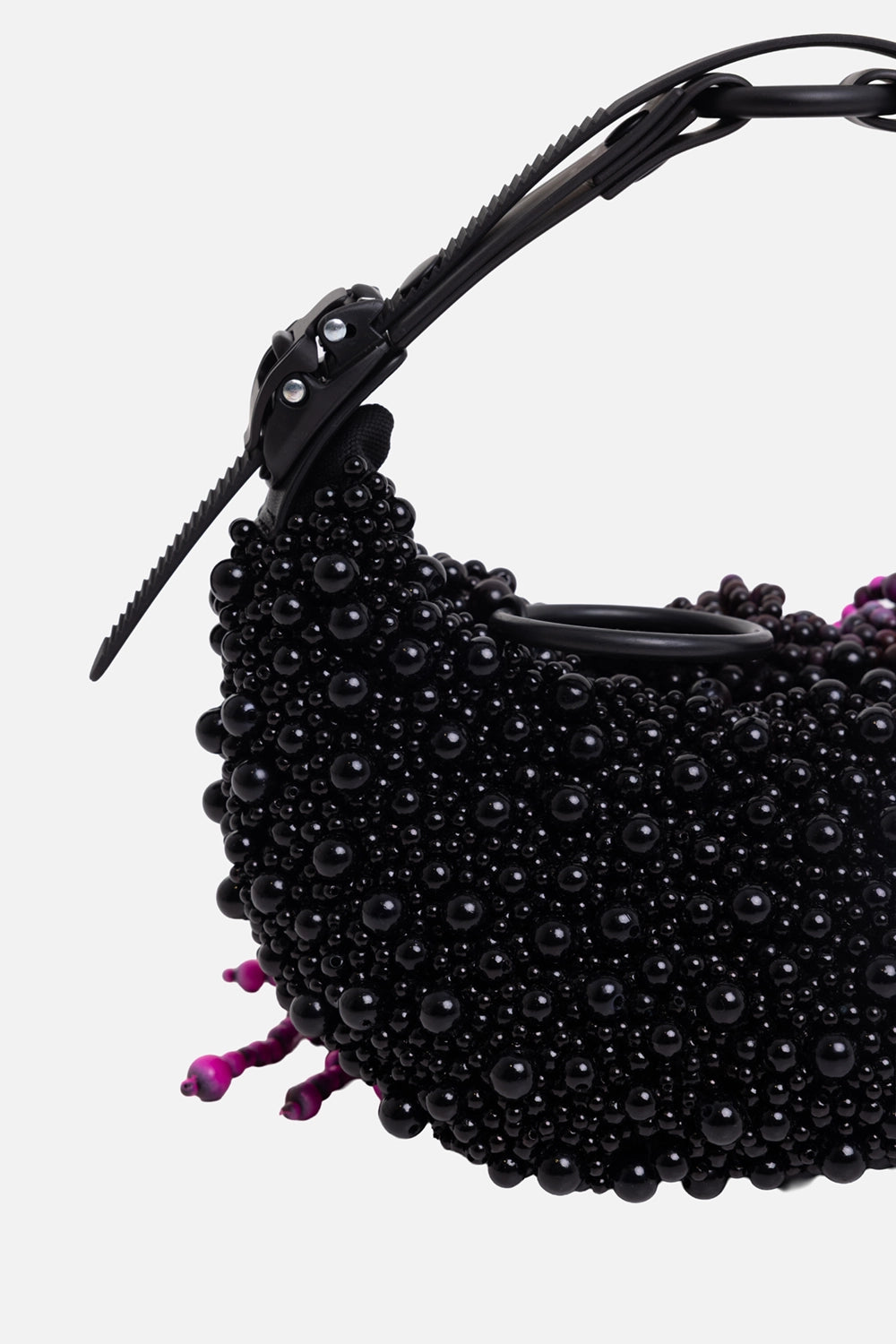 Innerraum unisex beaded half-moon bag in black, hardware close-up with matte carabiner handle and black beadwork