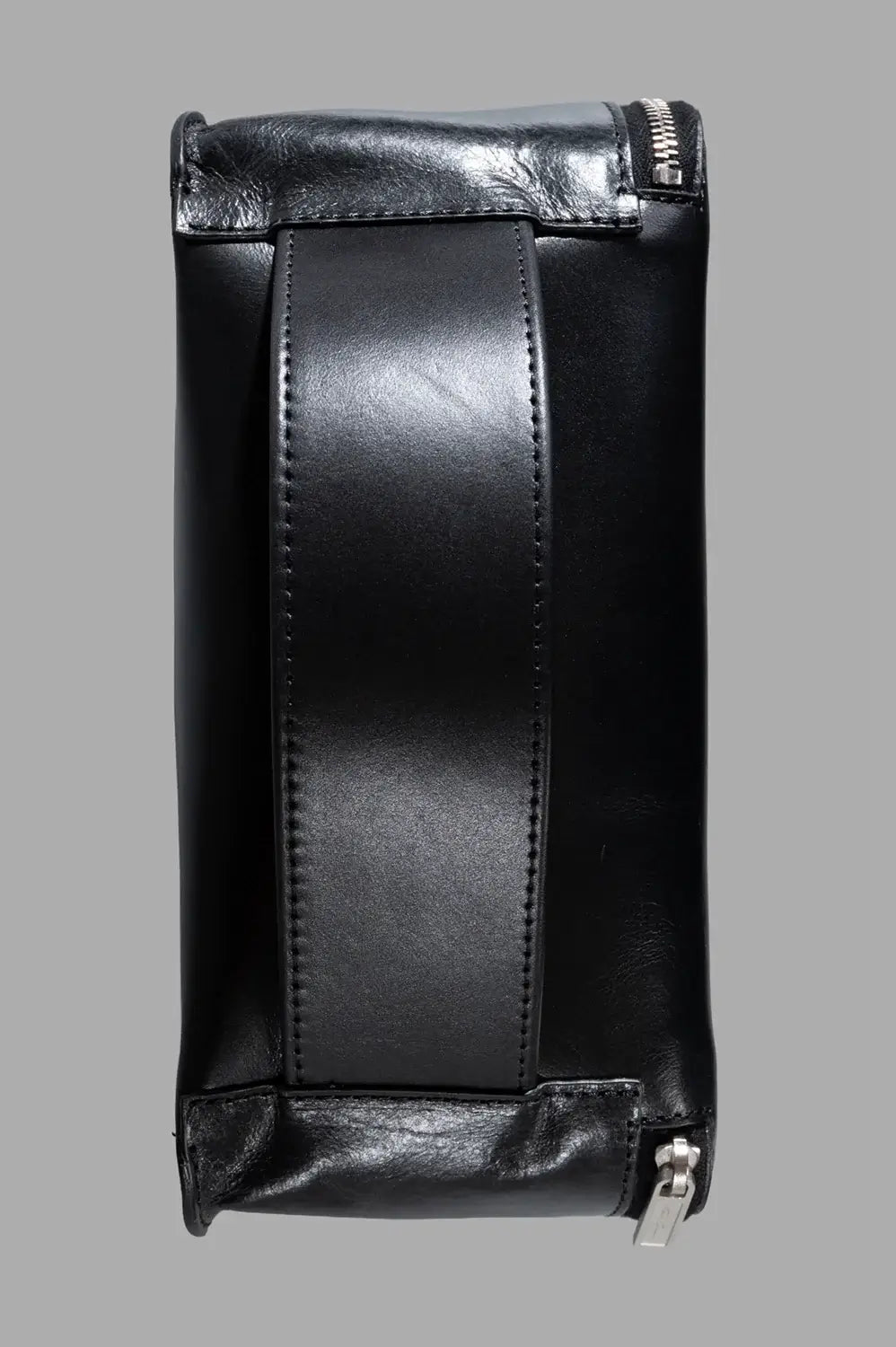 Rick Owens beauty case in black, back view with wide leather handle strap and silver zipper pull