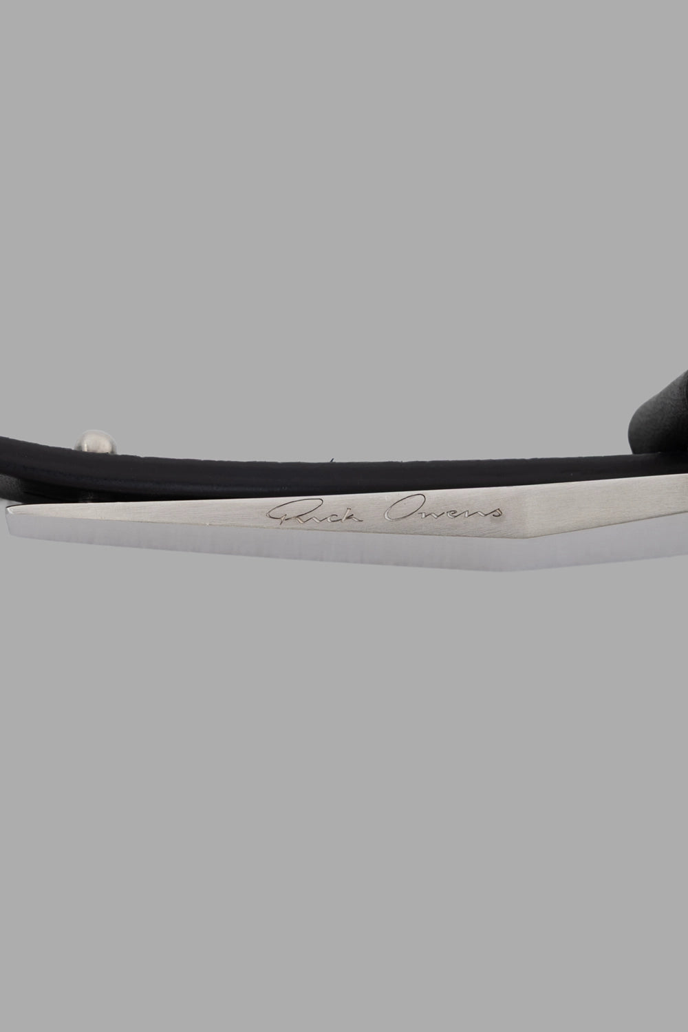 Rick Owens belt in black, hardware close-up, logo-engraved brass buckle detail