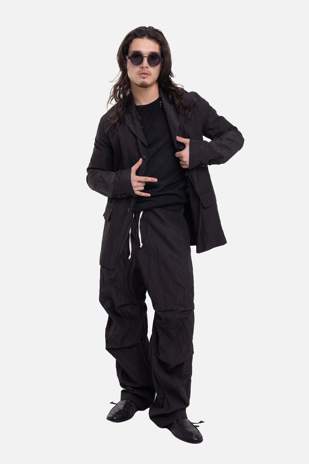 Masnada men's jacket in black, on-model full-length view with three-button front and relaxed tailoring