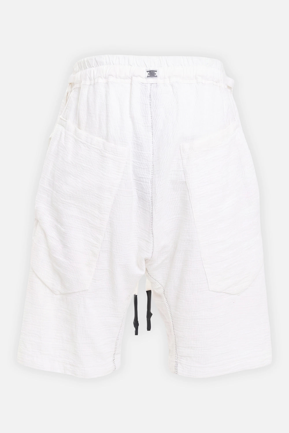 69 by Isaac Sellam men's shorts in white, back view with patch pockets, rear staple tab and black cord tips