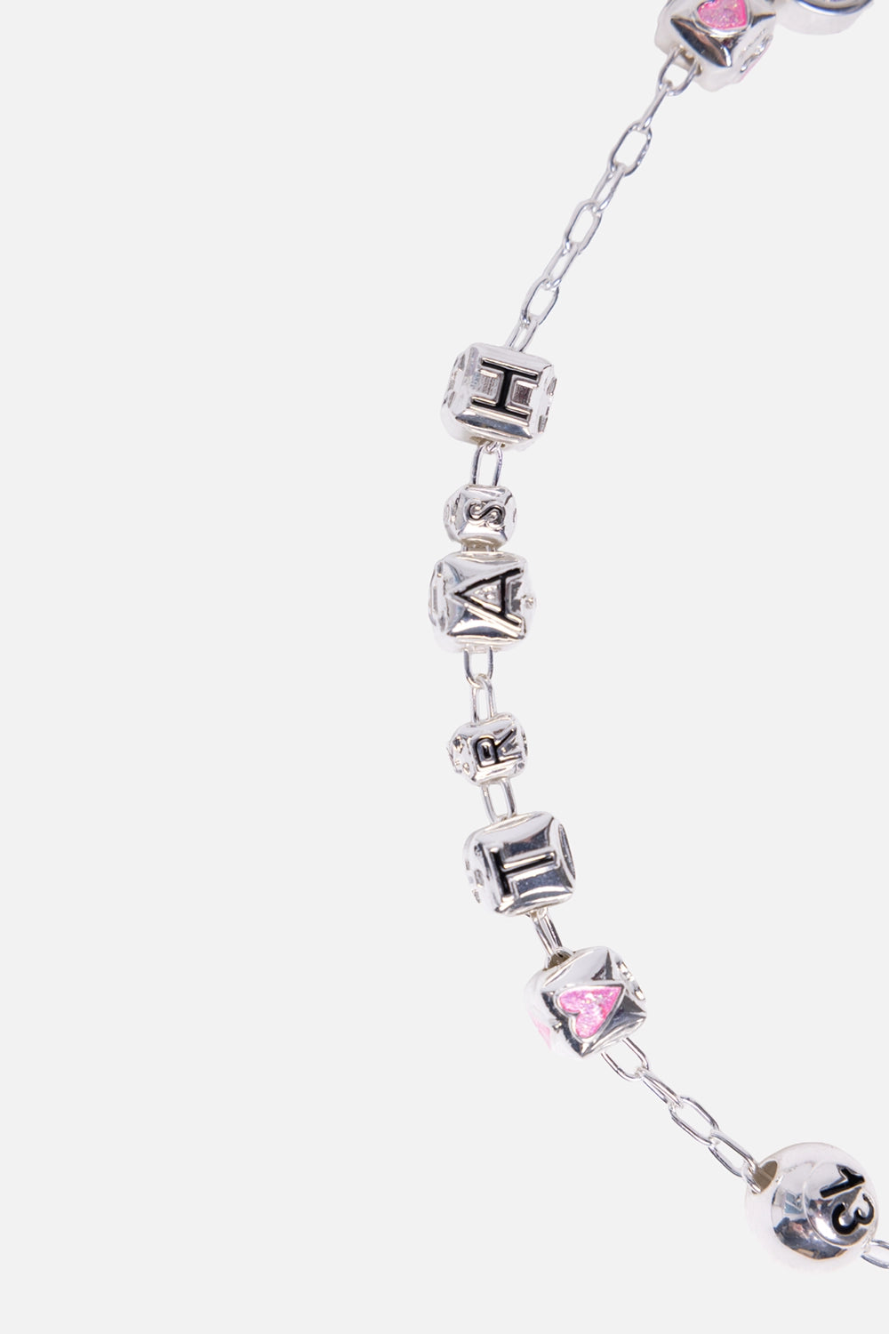 Biou multicolour necklace detail showing enamel heart bead and illustrated charm