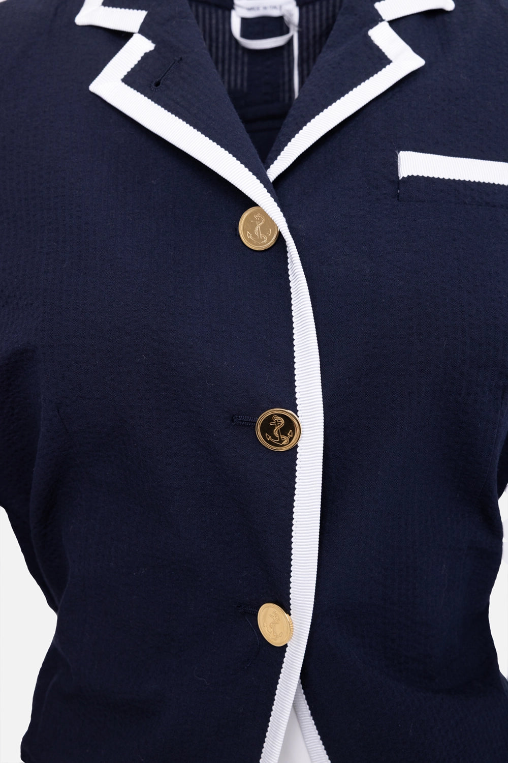 Pre-owned Thom Browne women's blazer in dark blue, close-up view, anchor motif buttons and contrast piping