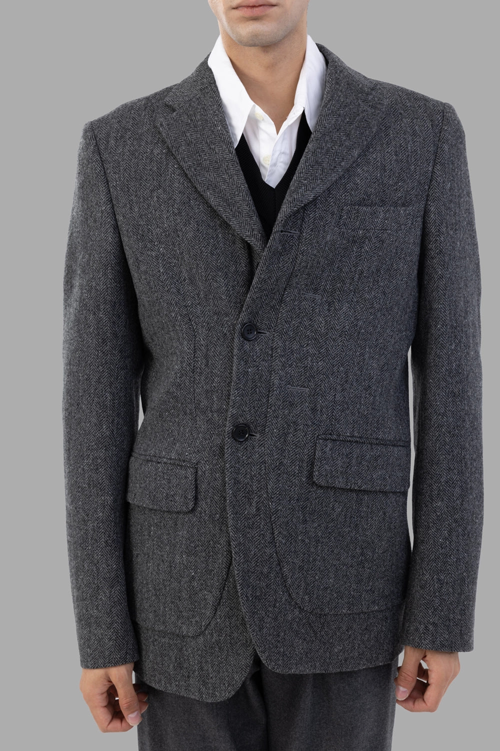Comme des Garçons blazer in grey herringbone, 3/4 view, rounded patch pockets and curved hem
