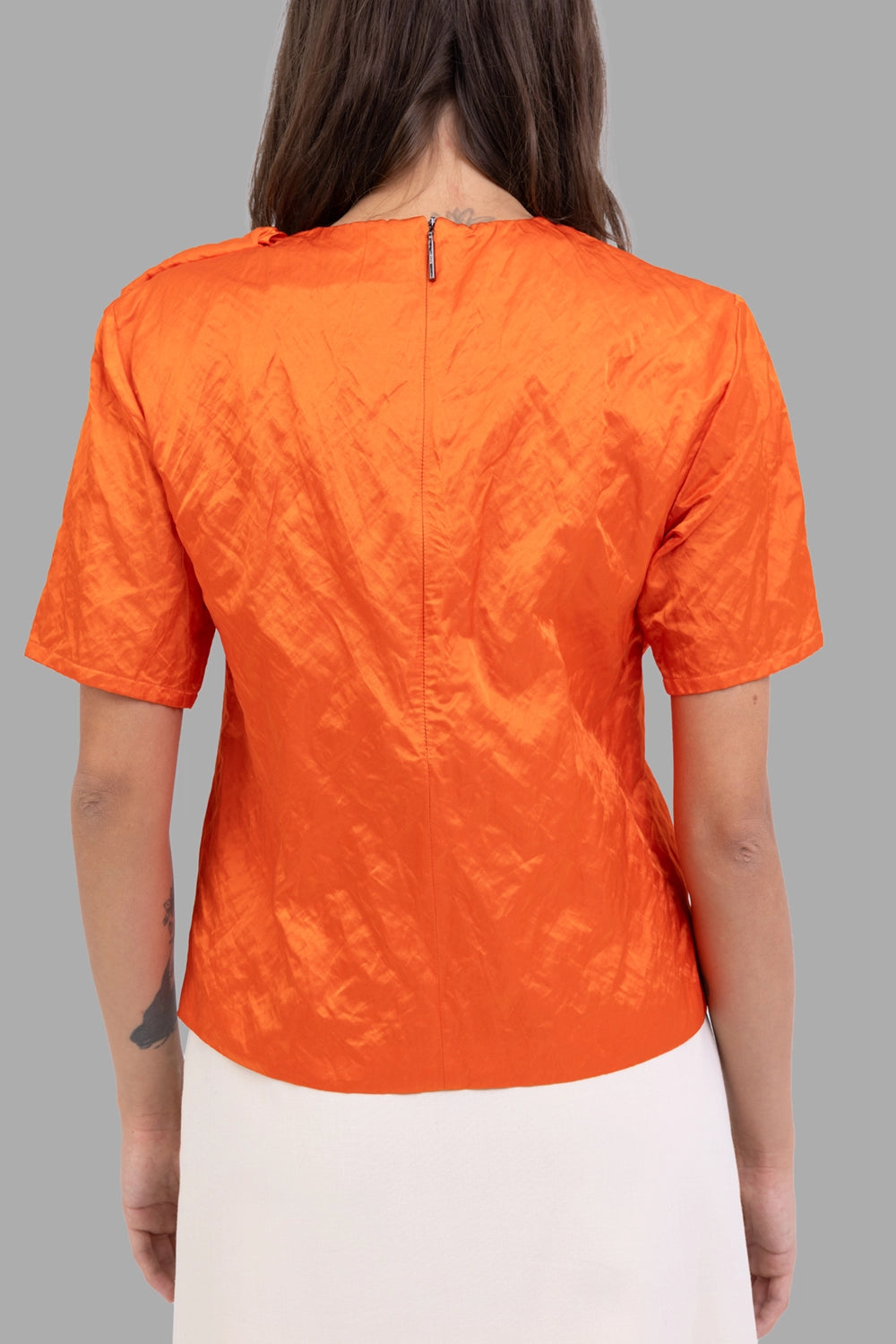 MSGM women bow-front blouse in orange, back view, hidden zip and fitted hem.