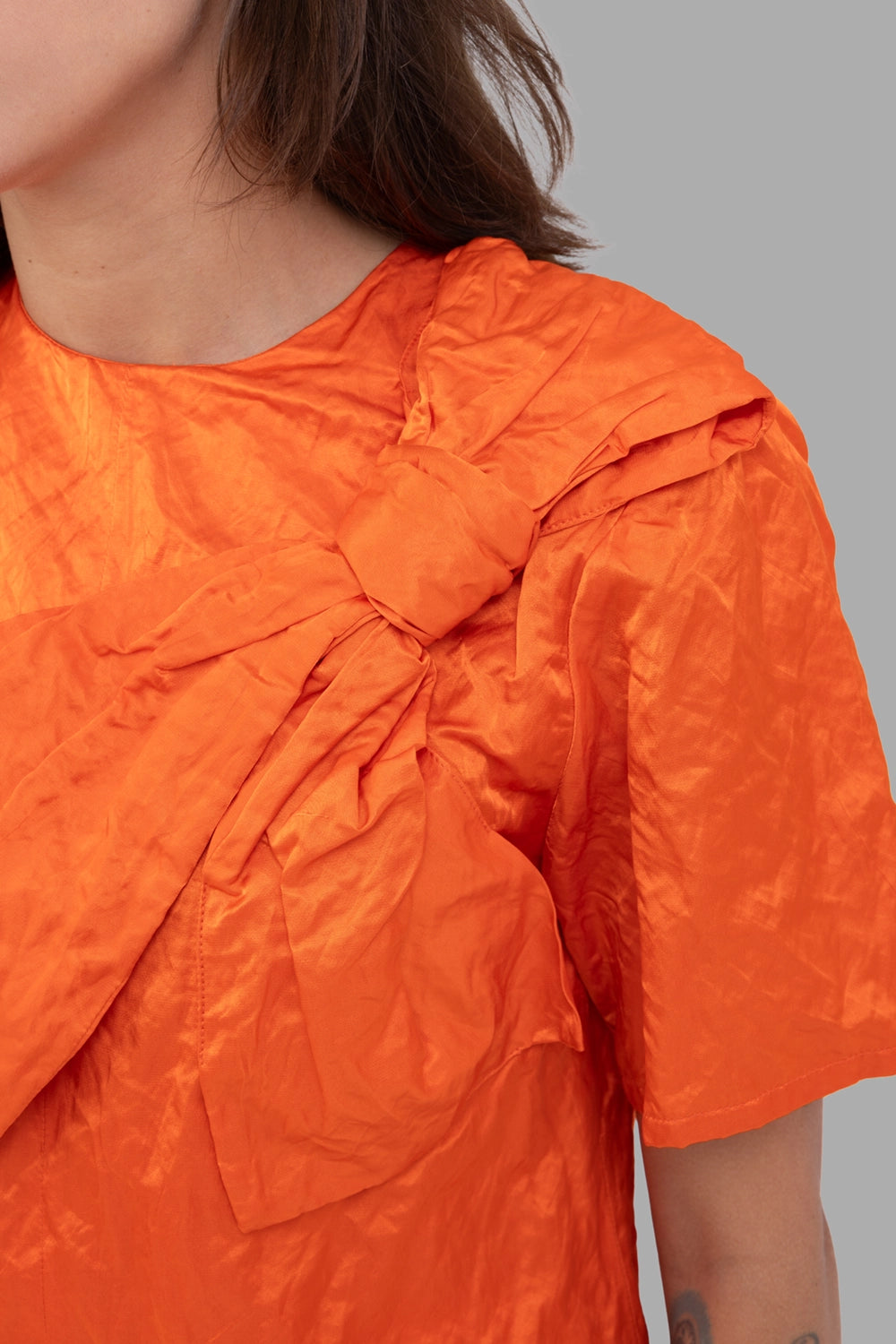 MSGM women bow-front blouse in orange, shoulder detail, knotted bow and crisp sheen.