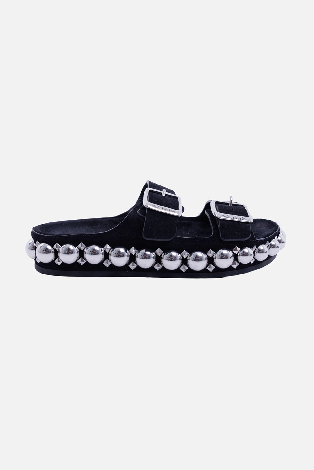 Alaïa women's Bombe suede slides in black, side view with silver sphere-and-pyramid studs and double buckles