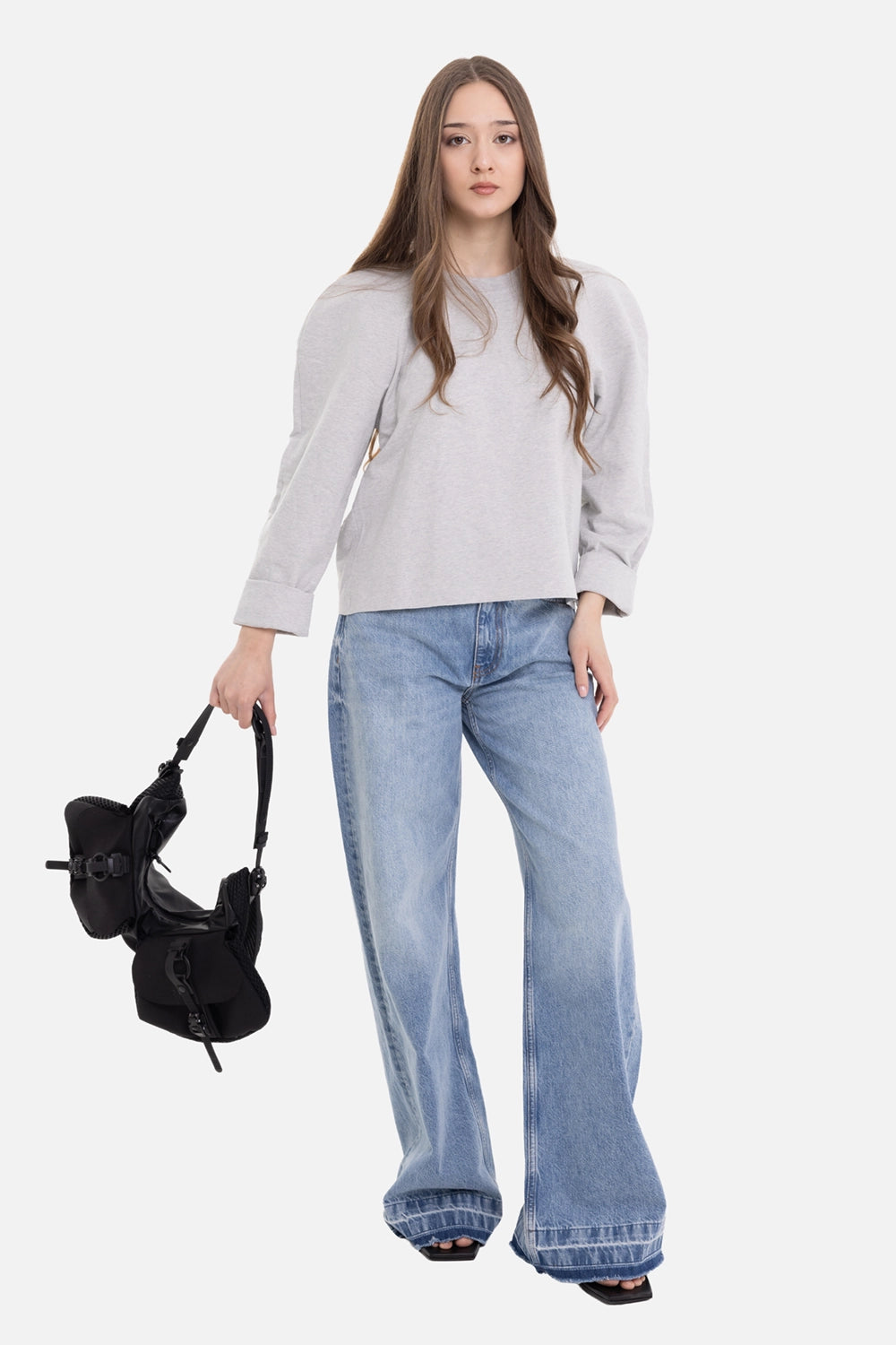 Norma Kamali women's sweatshirt in light heather grey, on-model full-length view, cropped raw hem