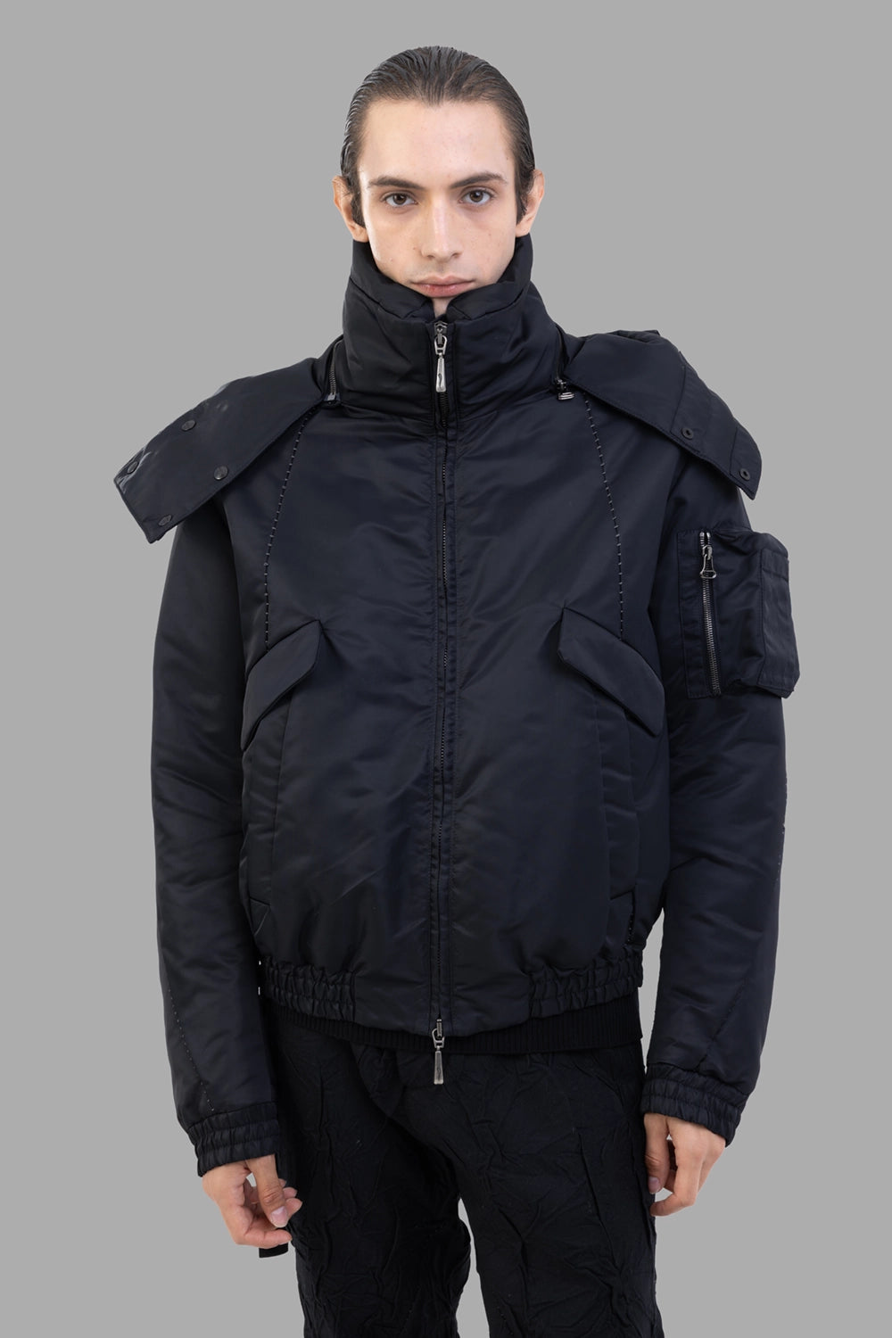 Masnada bomber jacket in black, front view, tall padded collar and two-way zip