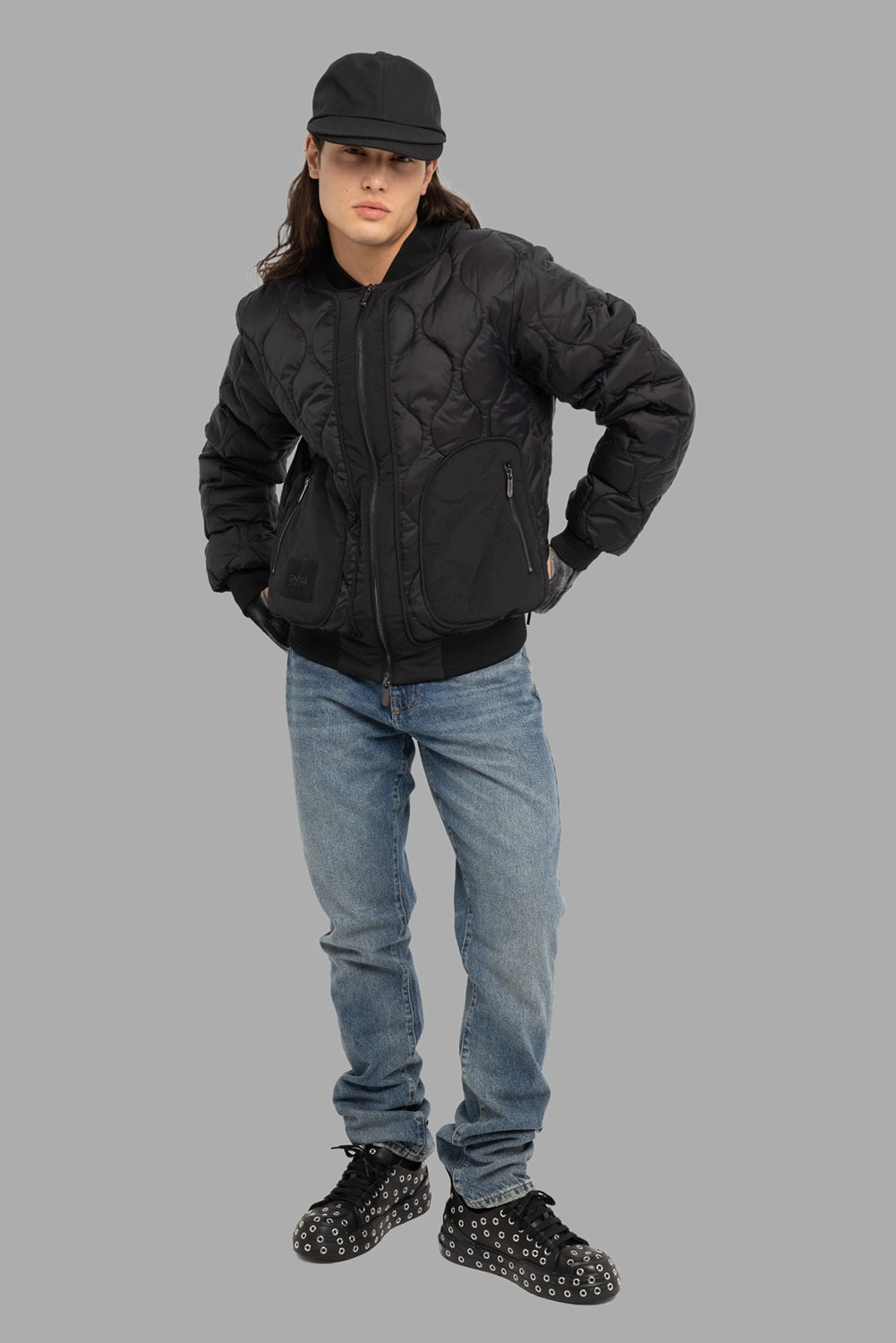 Gaëlle Paris men's bomber jacket in black, on-model full length, wave quilting and curved zip pockets