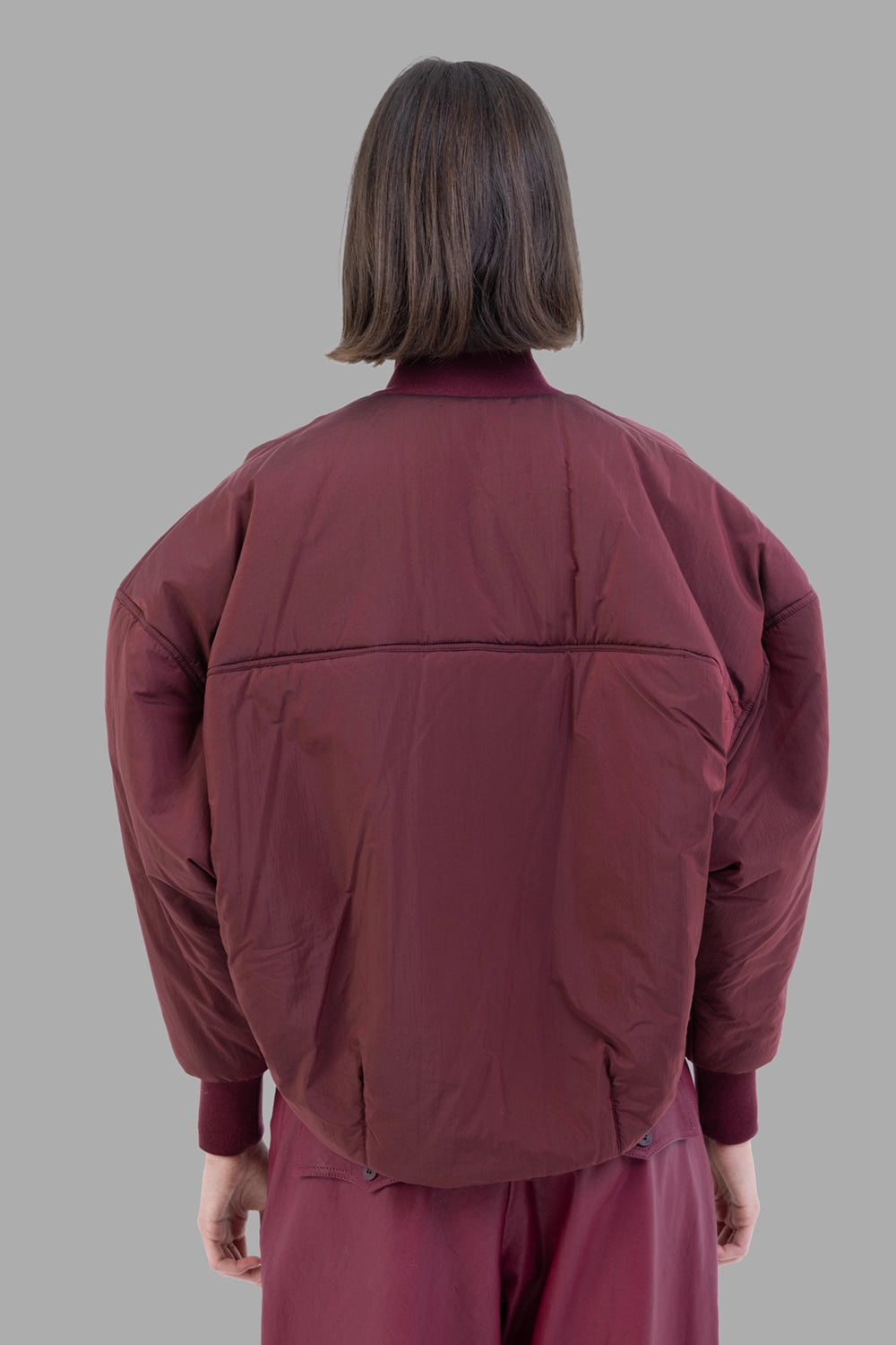 Gentryportofino women's bomber jacket in Borgogna, front view, metal zip, vertical panel seams and wide ribbed hem.