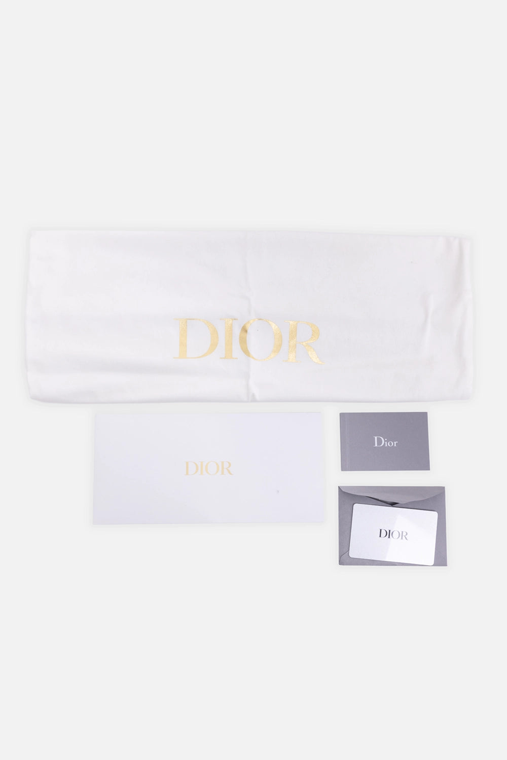 Pre-owned Christian Dior dust bag and cards in white, flat lay view, gold logo print