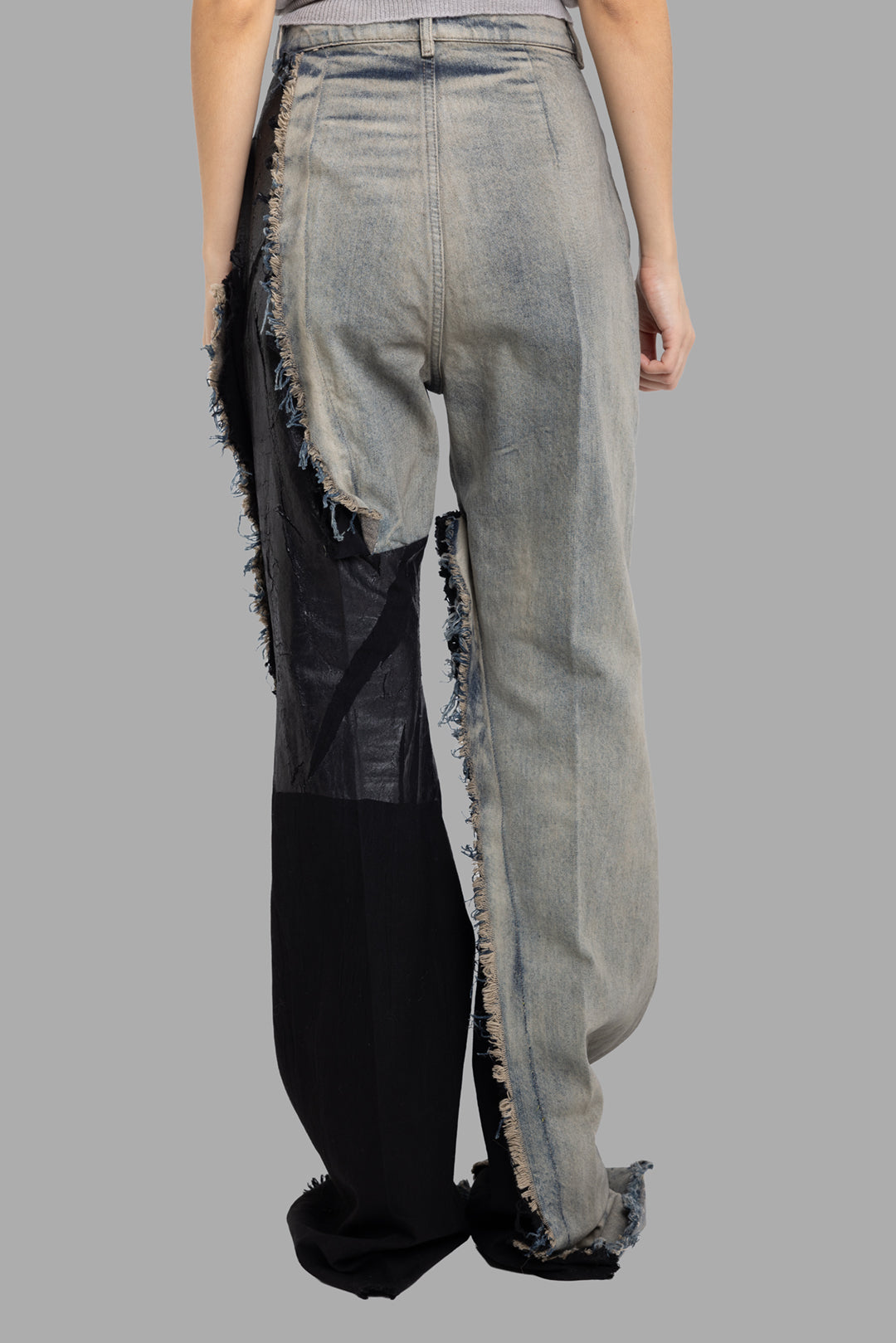 Rick Owens women's Bolan bootcut jeans in Dirty Hustler/Black, back view with contrast black panel and frayed hem seam.