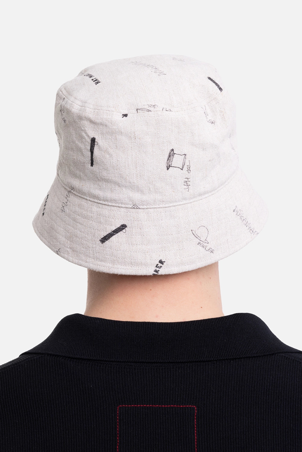 KIJIMA TAKAYUKI unisex bucket hat in ivory, back view, scattered sketch motifs across crown and brim