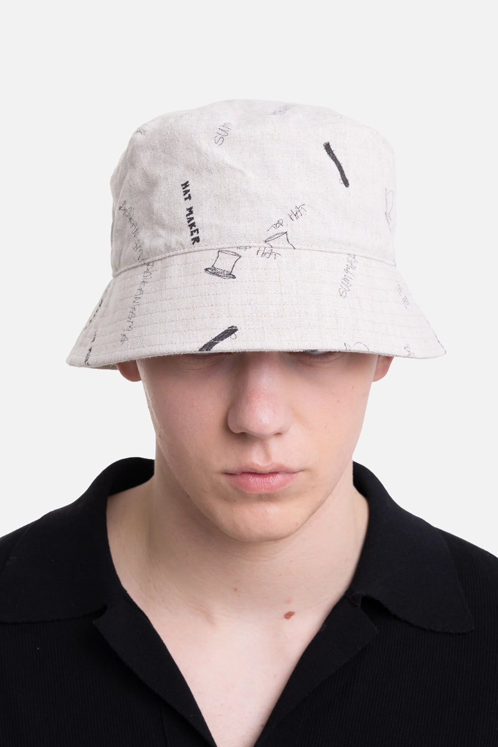 KIJIMA TAKAYUKI unisex bucket hat in ivory, front view, Hat Maker text and top-hat doodle print
