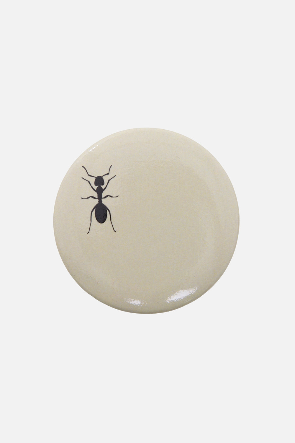 Marc Point unisex pin badge in ivory/black, front view, round button with ant graphic