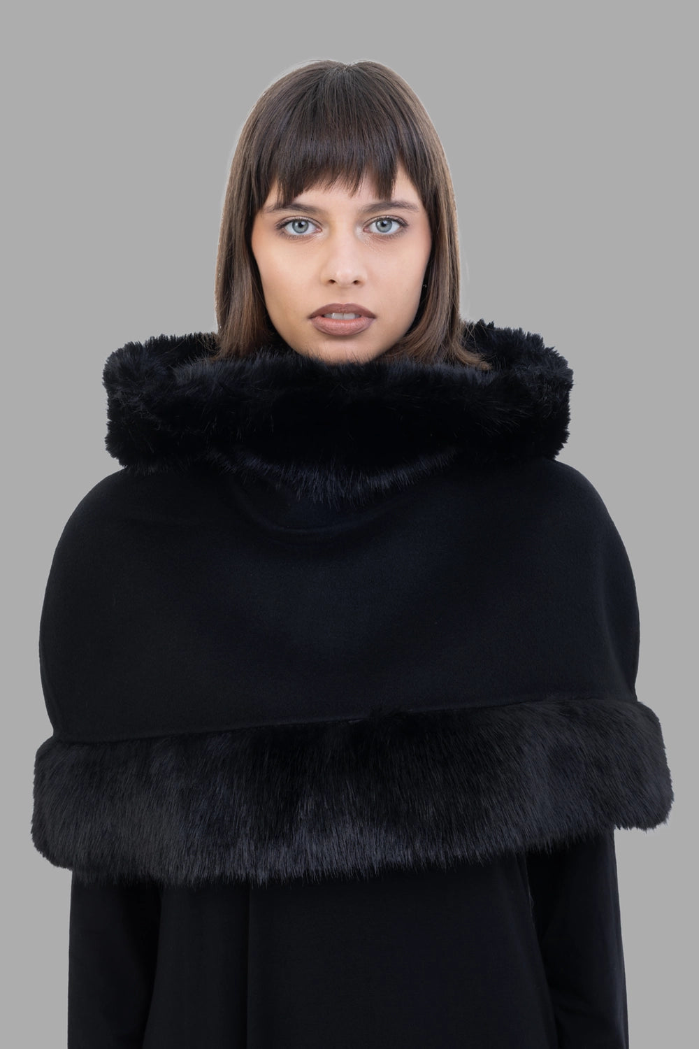By Malene Birger women cape in black, collar detail, hood folded as high collar with faux-fur edge.