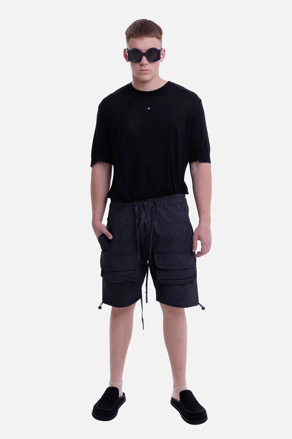 Justin Gall men's cargo floater shorts in black enzyme, full-length on-model view with relaxed drop-crotch fit