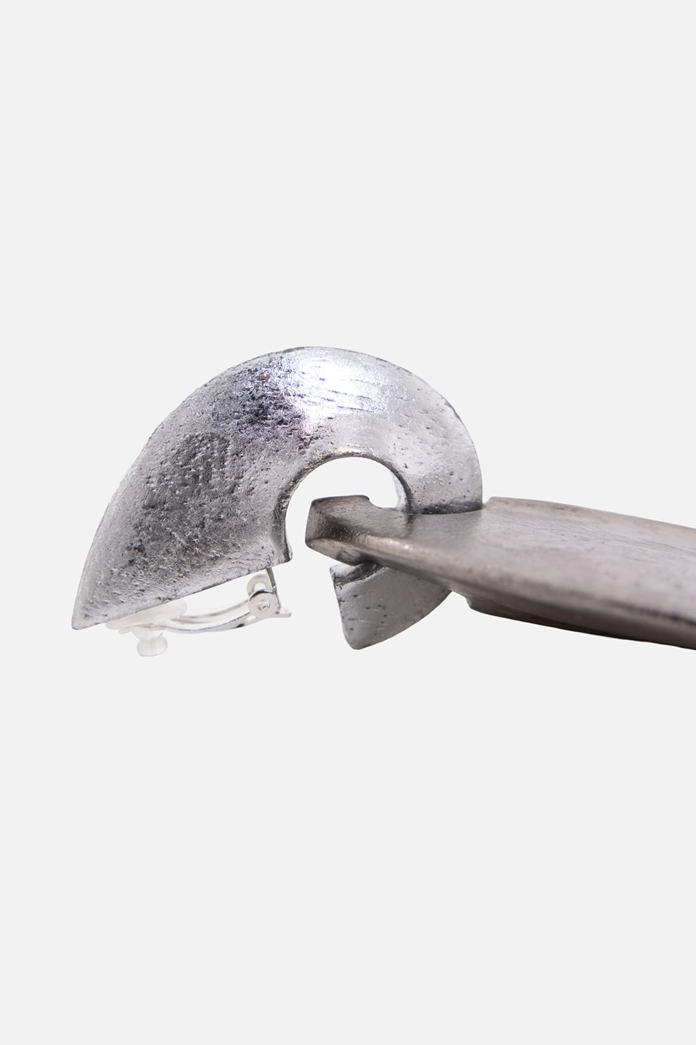Monies clip-on earrings in silver, side view with curved acacia shell and visible clip back