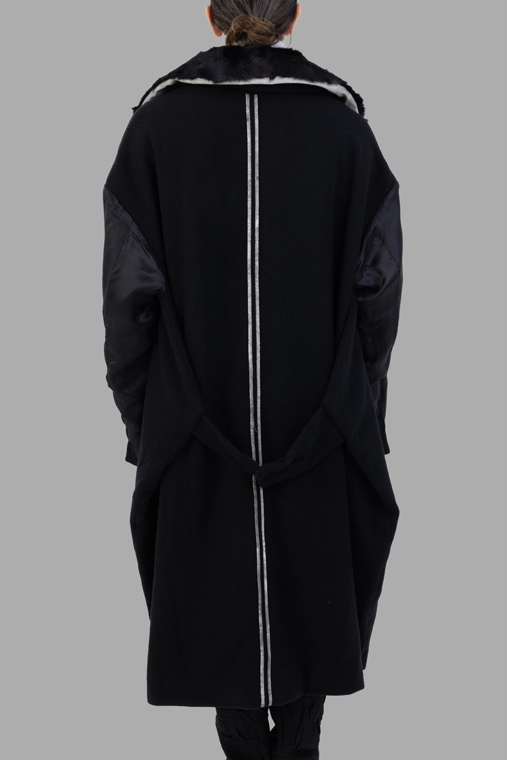 Giovanni Cavagna coat in black, back view, vertical tape detail and draped belt loop