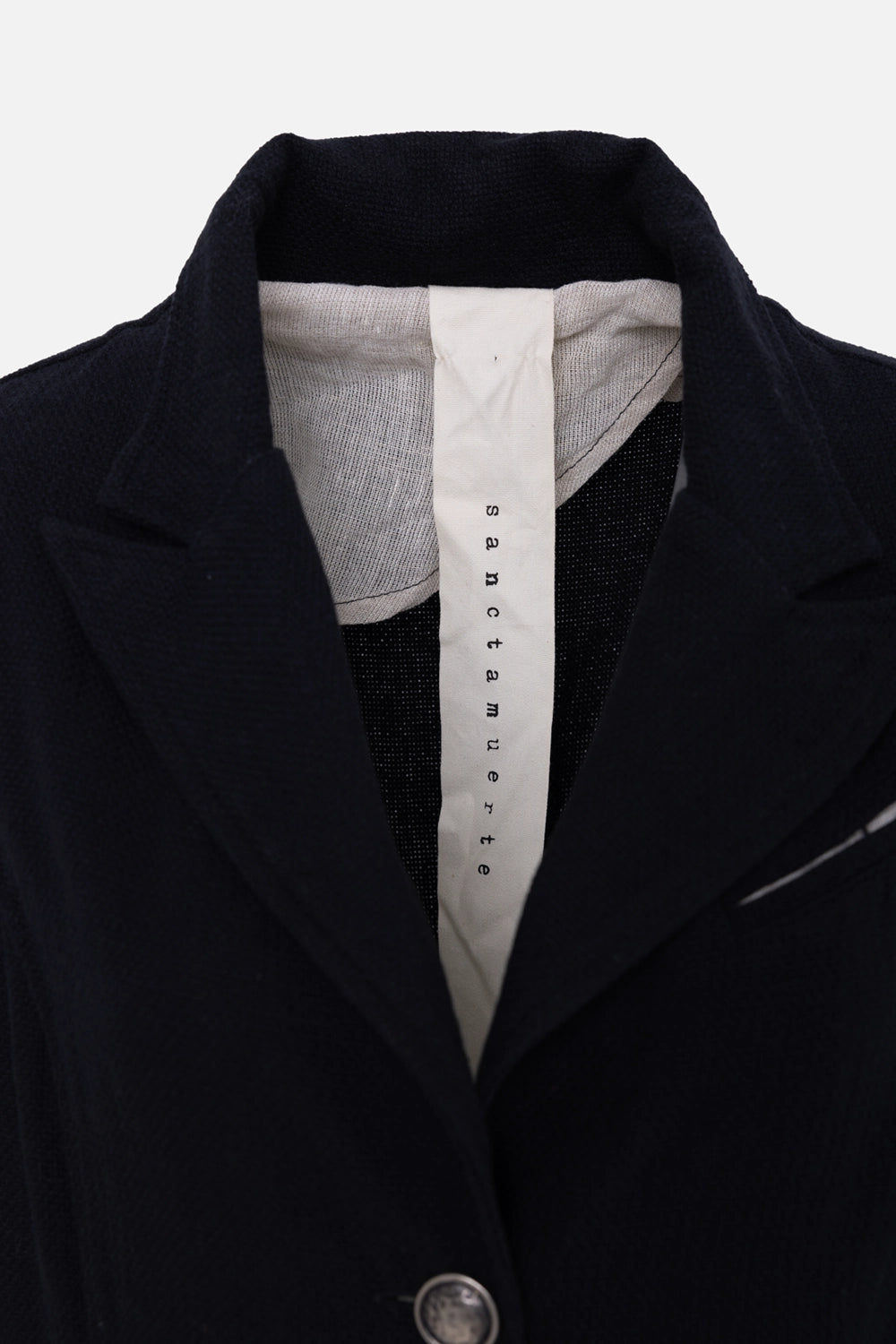 Pre-owned Sanctamuerte women's coat in black, collar close-up, notched lapel and branded label tape
