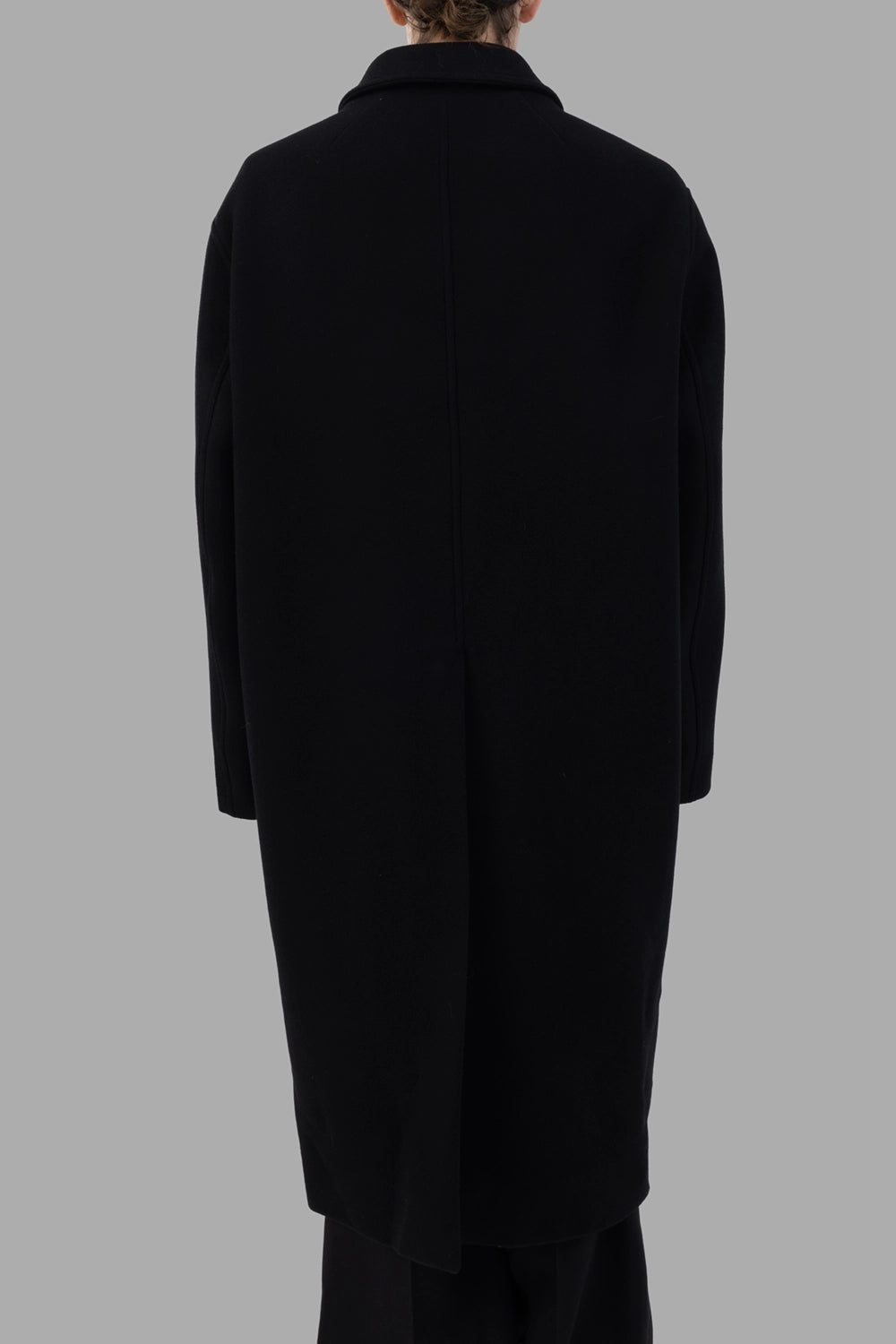 Rick Owens coat in black, front view, clean concealed placket and two flap pockets