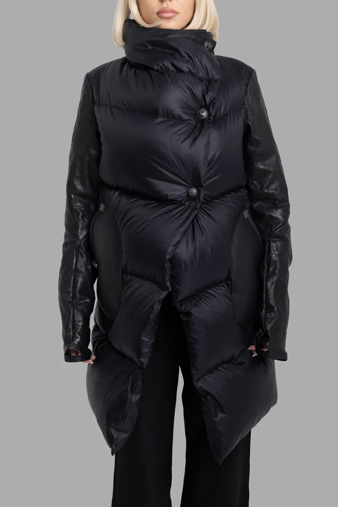 Isaac Sellam Experience unisex black coat, front close-up, asymmetric snap closure and high padded stand collar.