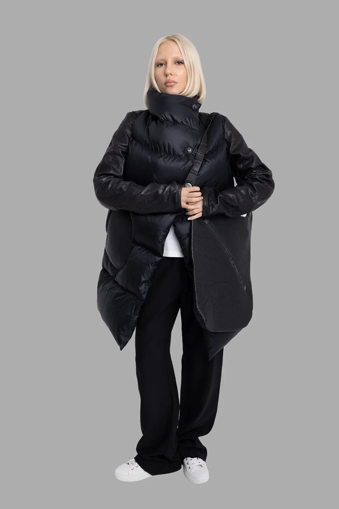 Isaac Sellam Experience unisex black coat, on-model full-length front view, sculptural padded body and leather sleeves.