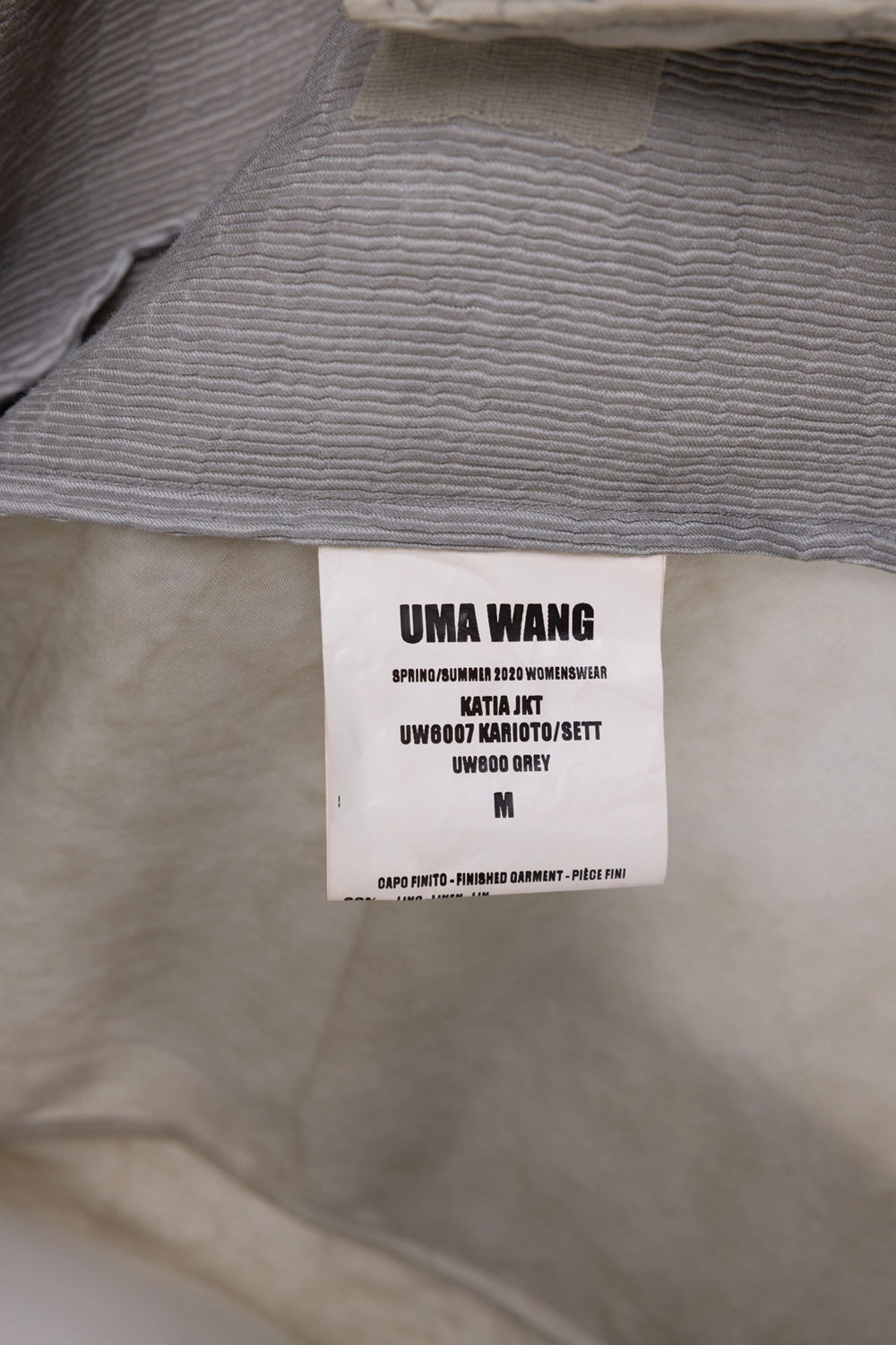 Pre-owned Uma Wang women's coat in grey, label close-up, Spring/Summer 2020 womenswear tag.